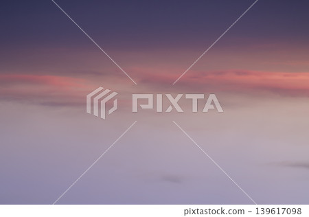 the sky in soft transitions, blending moody violets with the gentle glow of a receding sun. Long, slender ribbons of salmon-pink clouds stretch across the center, providing a warm contrast to the the sky in soft transitions, blending moody violets with the gentle glow of a receding sun. Long, slender ribbons of salmon-pink clouds stretch across the center, providing a warm contrast to the 139617098