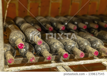 Old wine bottles aging in a cellar in Bzenec, Czechia Old wine bottles aging in a cellar in Bzenec, Czechia 139617545