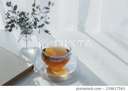 A peaceful morning with tea by the window and eucalyptus. A peaceful morning with tea by the window and eucalyptus. 139617563