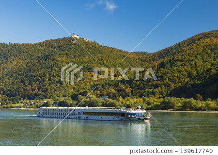 River cruise ship sailing Wachau Valley past Aggstein Castle River cruise ship sailing Wachau Valley past Aggstein Castle 139617740