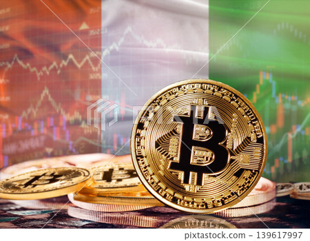 Bitcoin with Ivorian flag in the background. Investors in cryptocurrency and Blockchain Technology in Ivory Coast, Concept Bitcoin with Ivorian flag in the background. Investors in cryptocurrency and Blockchain Technology in Ivory Coast, Concept 139617997