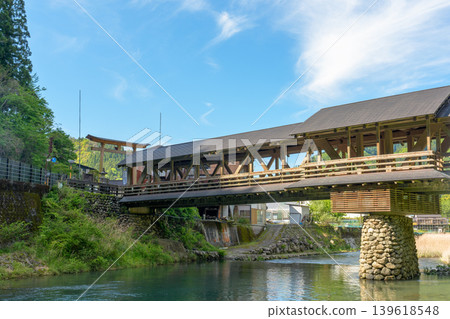 The beautiful wooden bridge of Mishima Shrine, spanning the Yusuhara River. The beautiful wooden bridge of Mishima Shrine, spanning the Yusuhara River. 139618548