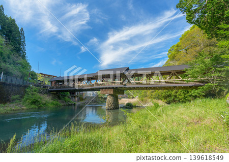 The beautiful wooden bridge of Mishima Shrine, spanning the Yusuhara River. The beautiful wooden bridge of Mishima Shrine, spanning the Yusuhara River. 139618549