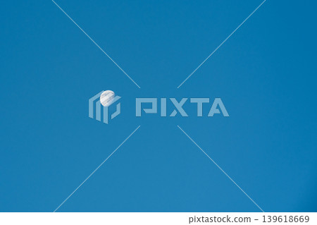 Daytime moon against blue sky . Copy space Daytime moon against blue sky . Copy space 139618669