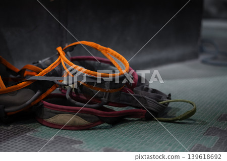 Climbing safety system with harness, carabiners, and belay device. Essential gear for rock climbing and indoor climbing walls to secure climbers and ensure safety. Climbing safety system with harness, carabiners, and belay device. Essential gear for rock climbing and indoor climbing walls to secure climbers and ensure safety. 139618692