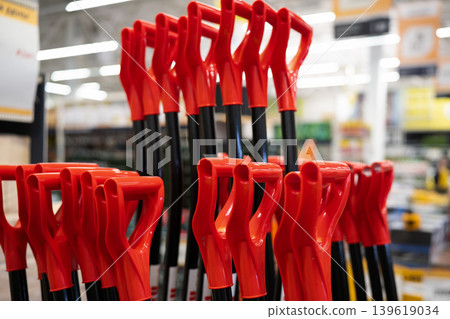 Red plastic shovel handles . Close up Red plastic shovel handles . Close up 139619034