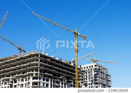 Midrise construction site with tower cranes, sustainable urban development progress Midrise construction site with tower cranes, sustainable urban development progress 139619304