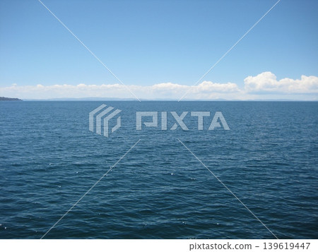 A view of Lake Titicaca with clouds stretching across the horizon. A view of Lake Titicaca with clouds stretching across the horizon. 139619447