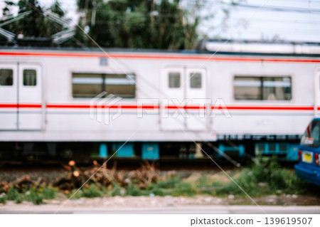 Fast-moving commuter train (KRL) passing through urban railway tracks in Indonesia 139619507