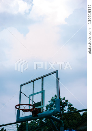 Basketball ring with net on public sports field Basketball ring with net on public sports field 139619552