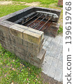 A brick barbecue grill installed in a park (viewed from an angle). 139619768