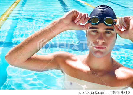 Swimming pool, serious and portrait of sports man ready for exercise, outdoor workout or practice. Aqua, water and face of competitive swimmer determined for waterpolo, fitness or summer cardio 139619810
