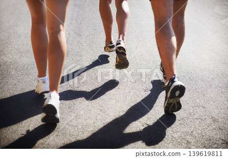 People, legs and running on road fitness for marathon practice for healthy cardio, training or exercise. Athletes, sneakers and jog on street for outdoor physical activity or speed, together or race People, legs and running on road fitness for marathon practice for healthy cardio, training or exercise. Athletes, sneakers and jog on street for outdoor physical activity or speed, together or race 139619811