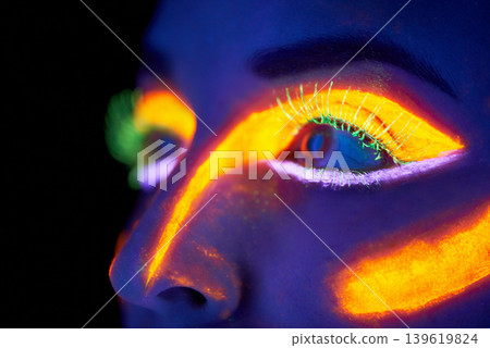 Eyes, art and creative with neon woman on black background in studio for bright vision or fantasy. Face, future and psychedelic with model in dark for galaxy or universe paint on glowing skin closeup Eyes, art and creative with neon woman on black background in studio for bright vision or fantasy. Face, future and psychedelic with model in dark for galaxy or universe paint on glowing skin closeup 139619824