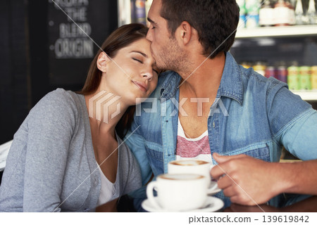 Love, kiss and couple drinking coffee in cafe, care and bonding together on valentines day date. Romance, man and woman in restaurant with tea for connection, commitment and relationship in shop Love, kiss and couple drinking coffee in cafe, care and bonding together on valentines day date. Romance, man and woman in restaurant with tea for connection, commitment and relationship in shop 139619842