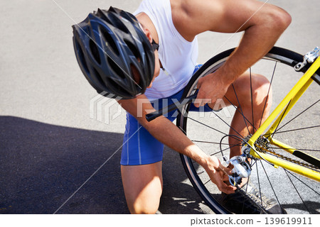 Man, bicycle and tyre service on road for safe cycling transport, performance or puncture. Male person, repair and gear improvement for speed or endurance or triathlon training, sport or practice Man, bicycle and tyre service on road for safe cycling transport, performance or puncture. Male person, repair and gear improvement for speed or endurance or triathlon training, sport or practice 139619911
