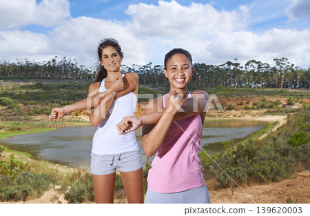 Young women, stretching or portrait in forest to exercise, outdoor or trees by lake in nature. Diversity, people and face for happy to workout, blue sky and wellness with body training in countryside 139620003