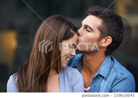 Love, kiss forehead and a happy couple outdoor for care, commitment and people in connection. Romance, man and woman together for bonding, smile in relationship and affection on valentines day date Love, kiss forehead and a happy couple outdoor for care, commitment and people in connection. Romance, man and woman together for bonding, smile in relationship and affection on valentines day date 139620045