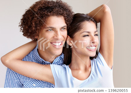 Love, smile and hug for romance with couple in studio together on gray background for dating. Trust, safety or security with happy young man and woman bonding or looking thoughtful about the future Love, smile and hug for romance with couple in studio together on gray background for dating. Trust, safety or security with happy young man and woman bonding or looking thoughtful about the future 139620055
