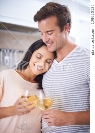 Couple, hug and wine glasses in kitchen, anniversary celebration and commitment to relationship. Happy people, home and bonding together in marriage, alcohol and toasting for support and romance Couple, hug and wine glasses in kitchen, anniversary celebration and commitment to relationship. Happy people, home and bonding together in marriage, alcohol and toasting for support and romance 139620123