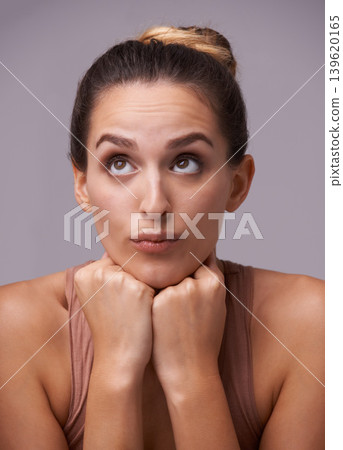 Woman thinking, looking up or skincare ideas with beauty cosmetics for healthy glow or dermatology. Isolated, results or female model in studio with natural shine or wellness on purple background 139620165