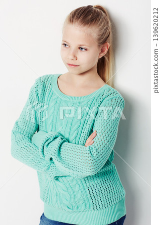 Child, relaxing and fashion pride in studio, cool and confidence by white background. Female person, girl and casual clothing or style by backdrop, kid and trendy winter sweater or arms crossed Child, relaxing and fashion pride in studio, cool and confidence by white background. Female person, girl and casual clothing or style by backdrop, kid and trendy winter sweater or arms crossed 139620212