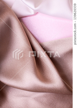 Abstract background in soft colors of silk fabrics on pink pearl paper. Beautiful trend texture Abstract background in soft colors of silk fabrics on pink pearl paper. Beautiful trend texture 139620339