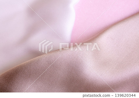 Abstract background in soft colors of silk fabrics on pink pearl paper. Beautiful trend texture Abstract background in soft colors of silk fabrics on pink pearl paper. Beautiful trend texture 139620344