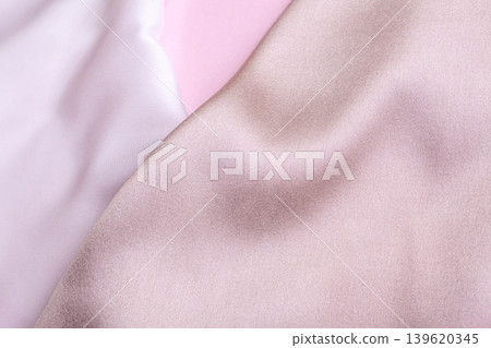 Abstract background in soft colors of silk fabrics on pink pearl paper. Beautiful trend texture Abstract background in soft colors of silk fabrics on pink pearl paper. Beautiful trend texture 139620345