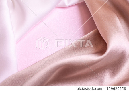 Abstract background in soft colors of silk fabrics on pink pearl paper. Beautiful trend texture Abstract background in soft colors of silk fabrics on pink pearl paper. Beautiful trend texture 139620358