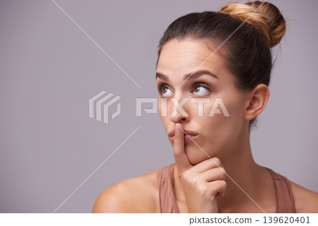 Woman thinking, touching lips or silence for secret, or privacy in gossip on grey background. Mouth, natural face or confident model isolated in studio with beauty for skincare or wellness 139620401