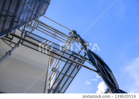 New siding and scaffolding that look up at the blue sky 139620519