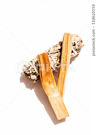 White sage bundle with two palo santo sticks on a white background White sage bundle with two palo santo sticks on a white background 139620559