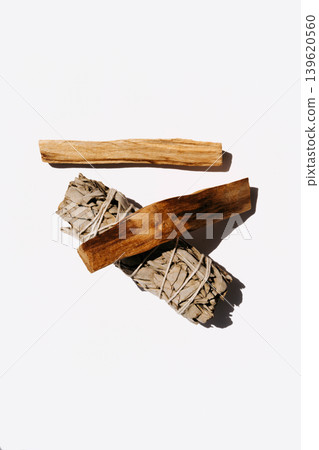White sage bundle with two palo santo sticks on a white background White sage bundle with two palo santo sticks on a white background 139620560
