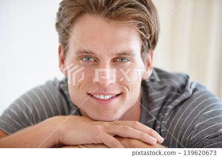 Happy, portrait and man relax in a house with positive attitude, mindset and good mood in his home. Face, smile and male person in a living room enjoying calm, easy and peaceful, day off or weekend 139620673