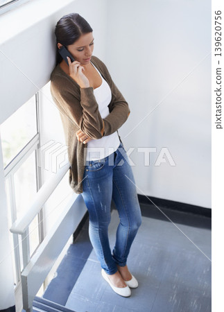 Phone call, talking or woman on break in office for communication, gossip or chat. Top view, window or female person listening to relax in conversation or speaking of news, feedback or networking Phone call, talking or woman on break in office for communication, gossip or chat. Top view, window or female person listening to relax in conversation or speaking of news, feedback or networking 139620756