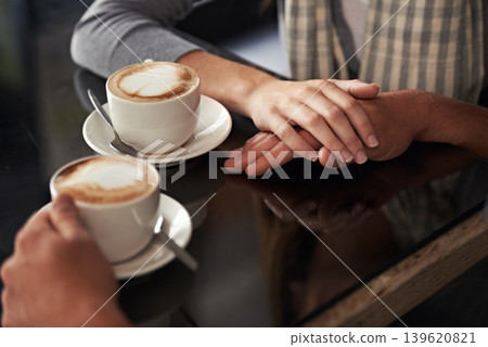Coffee cup, cafe and relax couple holding hands for support, empathy and care on morning date with caffeine beverage. Relationship, hospitality service and closeup of people bonding over drink mug 139620821