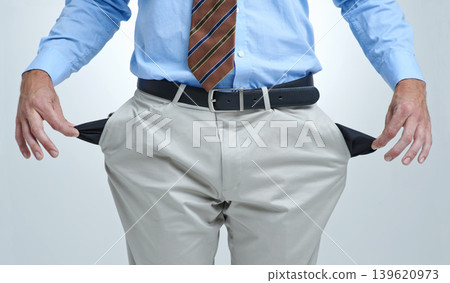 Businessperson, empty pocket and poor in studio, unemployment and bankruptcy by white background. Closeup, no money and financial trouble or bad investment, stock market crash and debt or broke Businessperson, empty pocket and poor in studio, unemployment and bankruptcy by white background. Closeup, no money and financial trouble or bad investment, stock market crash and debt or broke 139620973