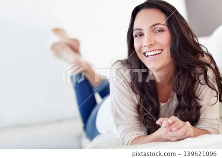 Woman, portrait and relax on sofa with happiness, wellness and leisure in comfortable in apartment. Greek female person and glow face with casual fashion, rest and weekend morning in holiday house 139621096