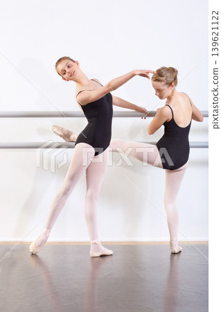 Dancing, girls and teenager in practice for ballet with fitness, happy or artistic performance routine. Dance studio, friends or creative class in preparation for entertainment, training or rehearsal Dancing, girls and teenager in practice for ballet with fitness, happy or artistic performance routine. Dance studio, friends or creative class in preparation for entertainment, training or rehearsal 139621122