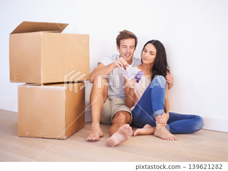 Couple, color swatches and decision, new home and interior design and real estate. Property, planning renovation and people moving with boxes and investment, mortgage and palette for choice for paint Couple, color swatches and decision, new home and interior design and real estate. Property, planning renovation and people moving with boxes and investment, mortgage and palette for choice for paint 139621282
