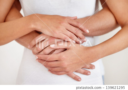 Love, support and hands of couple with hug closeup for care, trust and solidarity at home together. Commitment, comfort and zoom on people embrace with loyalty, respect and gratitude while bonding 139621295