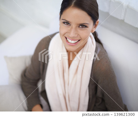 Portrait, woman and happy on sofa in home, relax and positive gen z for break in living room. Young person, face and smile on couch in wellness, casual fashion and calm for weekend in apartment 139621300