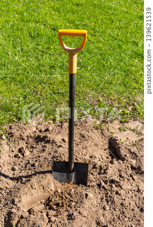 Shovel in soil. Shovel digging in the garden. Shovel in soil. Shovel digging in the garden. 139621539