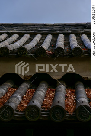 The roof of nijo jo castle, Kyoto, Japan. World Heritage Site. Roof tile pattern. Major tourist attraction in Kansai region in Japan. Japan famous historic architecture. Building exterior. The roof of nijo jo castle, Kyoto, Japan. World Heritage Site. Roof tile pattern. Major tourist attraction in Kansai region in Japan. Japan famous historic architecture. Building exterior. 139621597
