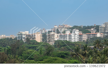 Modern neighborhood on the mountains with contemporary buildings surrounded by lush green forest Modern neighborhood on the mountains with contemporary buildings surrounded by lush green forest 139621972