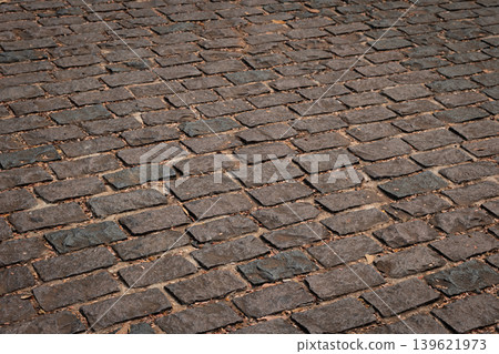 Cobblestone floor. Pavement, road is made of granite stone in sity Cobblestone floor. Pavement, road is made of granite stone in sity 139621973