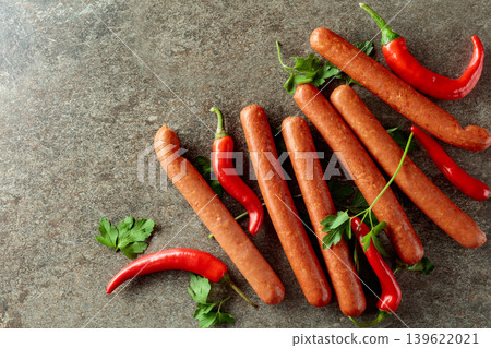 Sausages with red pepper and parsley on a stone table. Sausages with red pepper and parsley on a stone table. 139622021