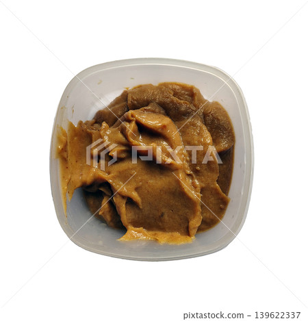 Smooth peanut butter in clear plastic container on white background top view. Smooth peanut butter in clear plastic container on white background top view. 139622337