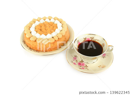 Delicious Caramel Sponge Cake with a Cup of Black Coffee Isolated on White Delicious Caramel Sponge Cake with a Cup of Black Coffee Isolated on White 139622345